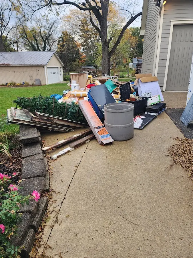 Dumpster being loaded with debris for Commercial Dumpster Rental in Alexander City